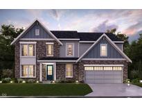Charming two-story home featuring a brick and gray siding exterior with a two-car garage and well-manicured lawn at 1101 Knoll Ct, Greenwood, IN 46143