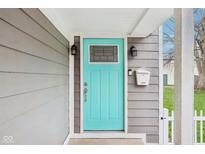 Close-up of a stylish turquoise front door with sidelights, enhancing curb appeal at 1804 Spann Ave, Indianapolis, IN 46203