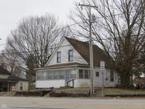 Charming two-story home featuring a cozy sunroom and a well-maintained yard, perfect for comfortable living at 290 S Marion St, Morgantown, IN 46160