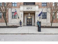 Stylish Hudson building facade with American and Indiana state flags flanking the main entrance at 355 E Ohio E St # 206, Indianapolis, IN 46204