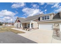 New construction home featuring a two-car garage, complementary siding colors, and a well-manicured lawn at 4408 W Preserve Pass, New Palestine, IN 46163