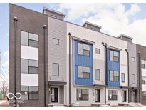 Modern townhome with varied exterior materials, a symmetrical window arrangement and individual covered entrances for each unit at 447 Leota St, Indianapolis, IN 46203