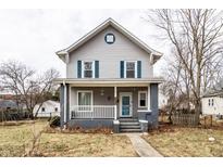 Charming two-story home with blue shutters, covered front porch, and inviting curb appeal at 4644 Cornelius Ave, Indianapolis, IN 46208