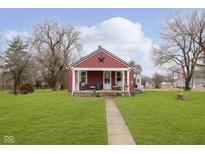 Charming single-story home featuring a cozy front porch and a well-manicured lawn at 5902 Hardegan St, Indianapolis, IN 46227