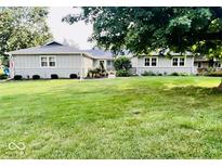 Charming single-story home with well-maintained lawn and beautiful landscaping at 6466 Kingswood Dr, Indianapolis, IN 46256