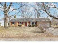 Charming single story home with red door, brick, attached garage and natural light at 7803 Delbrook Dr, Indianapolis, IN 46260