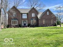 Charming brick two-story home featuring a well-manicured lawn and inviting curb appeal at 895 Baywood Ct, Columbus, IN 47201