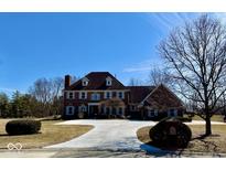Charming two-story brick home with mature trees and a spacious driveway at 10136 Summerlakes Dr, Carmel, IN 46032