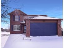 Charming two-story brick home with a blue garage door and well-maintained lawn at 1155 Dark Star Ct, Whiteland, IN 46184