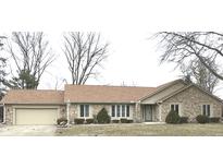 Charming single-story home featuring a stone facade, attached garage, and well-maintained landscaping at 1230 Linden Ln, Carmel, IN 46033