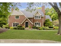 Charming two-story brick home with well-manicured lawn and mature landscaping at 13661 Smokey Ridge Pl, Carmel, IN 46033