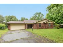 Charming single-story brick home with attached garage and mature trees at 1612 Westbay Ct, Indianapolis, IN 46260