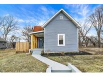 Charming home featuring light blue siding, a welcoming front porch, and a well-maintained front yard at 1842 Tallman Ave, Indianapolis, IN 46218