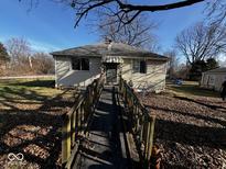 Quaint single-story home with ramp leading to the front door and a well-maintained yard on a sunny day at 2503 S Lyons Ave, Indianapolis, IN 46241