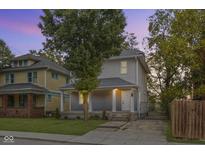 Charming two-story home featuring a welcoming front porch and well-maintained lawn at 3011 N New Jersey St, Indianapolis, IN 46205