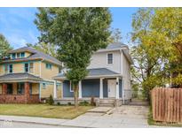 Charming two-story home featuring a covered porch and blue and white accents at 3011 N New Jersey St, Indianapolis, IN 46205