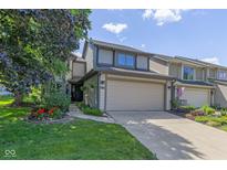 Charming two-story home with attached garage, landscaped yard, and inviting curb appeal at 3015 River Bay N Dr, Indianapolis, IN 46240