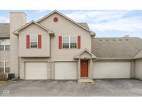 Charming two-story townhome with three car garage and red shutters at 3038 Wildcat Ln, Indianapolis, IN 46203