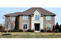 Charming brick front exterior home with a manicured lawn and landscaping and welcoming entrance at 3283 Homestretch Dr, Carmel, IN 46032