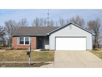 Charming single-Gathering home featuring a brick and siding facade, an attached two-car garage, and a well-maintained front lawn at 400 Lockerbie Ln, Pittsboro, IN 46167