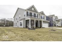 Charming two-story home with light gray siding, a brick facade, and a well-manicured front lawn at 4078 Omaha Dr, Bargersville, IN 46106