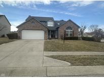 Charming two-story brick home featuring an attached two-car garage and neatly maintained front lawn at 4418 Tarragon Dr, Indianapolis, IN 46237