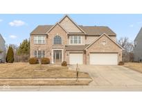 Charming two-story home with brick facade, two-car garage, and well-maintained lawn at 5344 Misthaven Ln, Greenwood, IN 46143