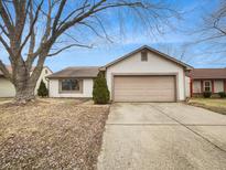 Charming single-story home with a two-car garage and a well-maintained front yard at 5721 Rosemont Ct, Indianapolis, IN 46254