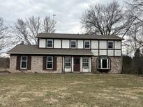 Two story home with brick and siding, dormer windows and brown shutters at 6797 W 900 N, McCordsville, IN 46055