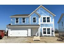 Exterior view of new two-story home under construction with attached two-car garage and blue sky background at 764 Oakleaf Dr, Greenfield, IN 46140