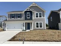 Charming two-story home featuring gray siding, blue shutters, and a two-car garage at 764 Oakleaf Dr, Greenfield, IN 46140