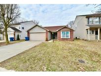 Charming single-story home with brick and siding exterior, complemented by a well-manicured front yard at 8208 Lake Tree Ln, Indianapolis, IN 46217