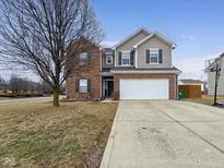 Traditional two-story home boasting a brick and siding facade, two-car garage, and a well-maintained lawn at 8430 Templederry Dr, Brownsburg, IN 46112