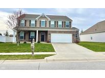 Charming two-story home with brick and vinyl siding and a well-manicured front yard at 8517 Hornady Dr, Indianapolis, IN 46239