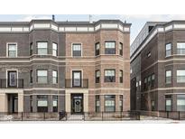 Stylish townhomes featuring a mix of brick facades and black-trimmed windows at 946 Berkhamsted Ln, Carmel, IN 46032