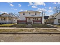 Charming two-story home featuring a welcoming front porch and classic architectural details at 1023 W 7Th St, Anderson, IN 46016
