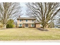 Charming two-story home with a brick and siding exterior and a well-maintained front lawn at 1120 Williamsburg Ln, Zionsville, IN 46077