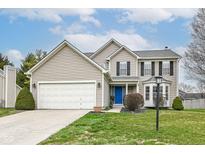 Charming two-story home with a well-maintained lawn, blue door, and attached two-car garage at 13153 Conner Knoll Pkwy, Fishers, IN 46038