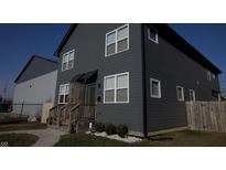 Contemporary two-story home featuring gray siding and white-trimmed windows with a quaint front entrance at 139 Mckim Ave, Indianapolis, IN 46201