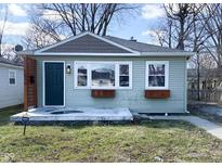 Charming home with muted green siding, gray accent shingles, and simple landscaping at 1836 N Riley Ave, Indianapolis, IN 46218