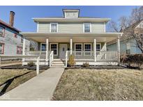 Charming two-story home featuring a large, inviting front porch with classic architectural details at 2308 Nowland Ave, Indianapolis, IN 46201