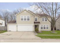 Charming two-story home with a three car garage and well-manicured lawn at 3113 Cassara Dr, Indianapolis, IN 46203