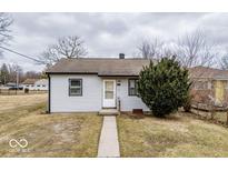 Charming single-story home with simple landscaping and a sidewalk leading to the front door at 3145 Stuart St, Indianapolis, IN 46218