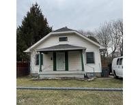 Cozy home featuring traditional siding, a covered front porch, and a well-maintained lawn at 3613 Schofield Ave, Indianapolis, IN 46218