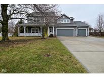 Charming two-story home with a three-car garage, inviting front porch and a meticulously maintained lawn at 3642 Homestead W Cir, Plainfield, IN 46168