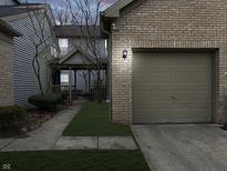 Charming two-story townhouse with a brick-lined garage and well-manicured lawn at 3708 Magenta Ln # 3, Indianapolis, IN 46214