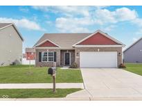 Charming single-Gathering home showcasing a well-manicured lawn and a two-car attached garage at 389 Longleaf Ln, Greenfield, IN 46140