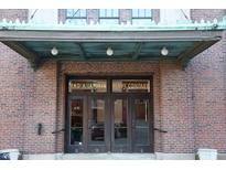 Brick building entrance with Indianapolis Glove Company signage, offering vintage charm at 430 N Park Ave # 304, Indianapolis, IN 46202
