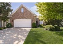 Charming brick home featuring a well-manicured lawn and a two-car garage at 4615 Crystal Lake Dr, Indianapolis, IN 46240
