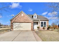 Charming brick home features an attached two-car garage, well-maintained lawn, and a cozy front porch at 509 Yorktown Ln, Avon, IN 46123